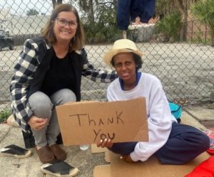 Jodi and homeless lady happily taking a picture