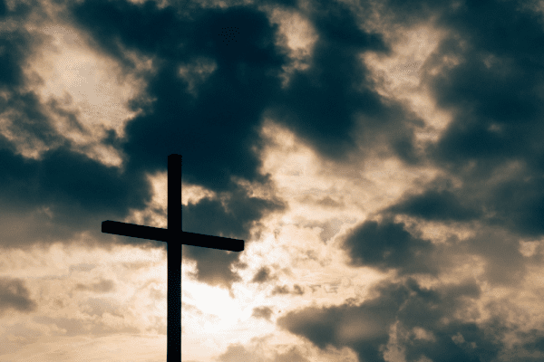 A silhouette holy cross beautifully standing in clouds